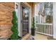 Charming front porch with stone accents and decorative plants at 65 Ashland Grove Ct, Sharpsburg, GA 30277