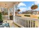Inviting porch with cozy seating and hanging floral baskets, offering a relaxing outdoor space at 65 Ashland Grove Ct, Sharpsburg, GA 30277