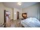 Bright bedroom featuring a white metal bed frame, hardwood floors, and a built in desk at 5825 Trailwood Ct, Suwanee, GA 30024