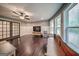 Bright living room with hardwood floors, ceiling fan, and natural light from the large windows at 5825 Trailwood Ct, Suwanee, GA 30024