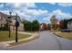 Scenic neighborhood street corner with street signs, well-maintained lawns, and beautiful fall foliage at 5825 Trailwood Ct, Suwanee, GA 30024