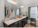 Bathroom featuring double vanity with nice countertops, fixtures, and mirrors at 340 Layfield Dr, Jonesboro, GA 30238