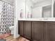 A well-lit bathroom with vanity, dark cabinets, and a shower with patterned curtain at 340 Layfield Dr, Jonesboro, GA 30238