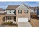 Charming two-story home featuring brick and gray siding, a two-car garage, and a welcoming front porch at 340 Layfield Dr, Jonesboro, GA 30238