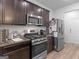 Stylish kitchen featuring stainless steel appliances, dark cabinets, and granite countertops at 340 Layfield Dr, Jonesboro, GA 30238