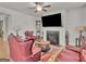 Charming living room featuring a fireplace, a ceiling fan, and leather couches at 340 Layfield Dr, Jonesboro, GA 30238