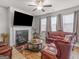 Elegant living room showcasing leather sofas, a fireplace, and a ceiling fan at 340 Layfield Dr, Jonesboro, GA 30238