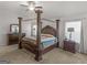 Main bedroom featuring a canopy bed, ceiling fan, and bedside tables at 340 Layfield Dr, Jonesboro, GA 30238