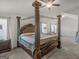 Main bedroom featuring a bed with ornate wood frame and ceiling fan at 340 Layfield Dr, Jonesboro, GA 30238