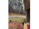 Back yard featuring a brick patio, privacy fence, and treed landscape at 5207 Sw West Shore Dr, Conyers, GA 30094