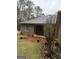 The exterior features a brick patio and covered deck on a cloudy day at 5207 Sw West Shore Dr, Conyers, GA 30094