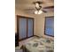 Bedroom featuring a ceiling fan, a window, and sliding glass doors at 5207 Sw West Shore Dr, Conyers, GA 30094