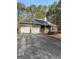 Brick home with an attached two-car garage, solar panels and a spacious driveway at 5207 Sw West Shore Dr, Conyers, GA 30094