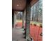 Inviting porch area with brick columns overlooking a mulched yard on a rainy day at 5207 Sw West Shore Dr, Conyers, GA 30094