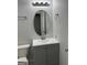 Bathroom with gray vanity, decorative oval mirror, chrome faucet, and contemporary overhead lighting at 1436 Heritage Court Ct, Villa Rica, GA 30180