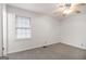 Well-lit bedroom with neutral paint, ceiling fan, carpet, and a window that offers ample natural light at 1436 Heritage Court Ct, Villa Rica, GA 30180