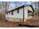Rear exterior view of the home featuring car port and white siding at 1436 Heritage Court Ct, Villa Rica, GA 30180