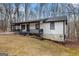 Exterior view of the home featuring a covered front porch and a lush, green lawn at 1436 Heritage Court Ct, Villa Rica, GA 30180