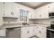 Well-lit kitchen featuring white cabinets, modern countertops, and stainless steel appliances at 1436 Heritage Court Ct, Villa Rica, GA 30180