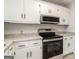 Stainless steel appliances, speckled counter tops, and white cabinets adorn this modern kitchen at 1436 Heritage Court Ct, Villa Rica, GA 30180