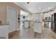 Open kitchen layout with an island, stainless steel appliances, granite countertops, and hardwood flooring at 417 Plantain Ter, Peachtree City, GA 30269