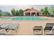 Large community swimming pool area with lounge chairs, lifeguard stand, and clubhouse at 417 Plantain Ter, Peachtree City, GA 30269