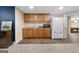 Basement featuring a kitchenette with wooden cabinets and a white fridge at 605 Clearwater Ct, Mcdonough, GA 30252