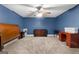 Spacious bedroom with fan and neutral carpet complemented by traditional wooden furniture at 605 Clearwater Ct, Mcdonough, GA 30252