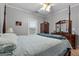 Bedroom with a four poster bed, light gray walls, and wooden furniture at 605 Clearwater Ct, Mcdonough, GA 30252