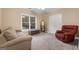 Bedroom with neutral walls, two couches, and a large window at 605 Clearwater Ct, Mcdonough, GA 30252