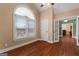 Bedroom featuring hardwood floors, a window with blinds, and a doorway leading to another room at 605 Clearwater Ct, Mcdonough, GA 30252