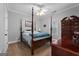 Bedroom with wooden furniture and a four-poster bed with a blue blanket at 605 Clearwater Ct, Mcdonough, GA 30252