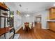 Cozy dining room with hardwood floors, decorative chandelier, table and chairs, and a door to the outside at 605 Clearwater Ct, Mcdonough, GA 30252