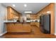 Spacious kitchen featuring wood cabinets, black appliances, and a breakfast bar at 605 Clearwater Ct, Mcdonough, GA 30252