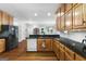 Traditional kitchen featuring wood cabinetry, granite countertops, and stainless steel appliances at 605 Clearwater Ct, Mcdonough, GA 30252