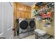 Laundry room with a washer and dryer set, cabinets and wire shelving at 605 Clearwater Ct, Mcdonough, GA 30252