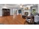 Open living room with hardwood flooring, a fireplace, and views into other rooms at 605 Clearwater Ct, Mcdonough, GA 30252