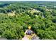 Aerial view of home nestled in a lush, green, wooded area at 6690 Bridge Brook Ovlk, Cumming, GA 30028