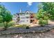 Expansive backyard view with a multi-tiered deck and lush landscaping at 6690 Bridge Brook Ovlk, Cumming, GA 30028