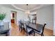 Well-lit dining room featuring hardwood floors, a dark wood table with seating for six, and elegant trim at 6690 Bridge Brook Ovlk, Cumming, GA 30028