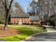 Charming two-story brick home featuring a manicured lawn and mature trees at 1121 Valley Ridge Ct, Marietta, GA 30067