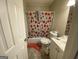 Bathroom with toilet, shower, sink and a floral shower curtain at 6861 Wendy Jean Dr, Morrow, GA 30260