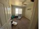 Bedroom with a ceiling fan, carpeted floors, and large window with natural light at 6861 Wendy Jean Dr, Morrow, GA 30260