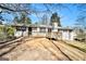 Rear exterior view showcasing the spacious deck and the white-bricked architecture of the home at 5595 Richland Dr, Douglasville, GA 30135