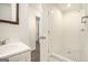 Bathroom features a standing shower with white tile, contrasted by black and white patterned floors at 5595 Richland Dr, Douglasville, GA 30135