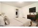 A well-lit bedroom featuring wood flooring, a television, and easy closet access at 5595 Richland Dr, Douglasville, GA 30135