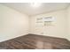 An empty bedroom showcasing wood-look floors and bright natural light through one window at 5595 Richland Dr, Douglasville, GA 30135