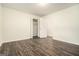 An empty bedroom features sleek, wood-look flooring and a closet, providing ample storage solutions at 5595 Richland Dr, Douglasville, GA 30135