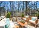 Relaxing outdoor deck area furnished with comfortable seating and a charming wooden coffee table at 5595 Richland Dr, Douglasville, GA 30135