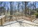 Spacious wooden deck offering a peaceful view of the surrounding wooded landscape at 5595 Richland Dr, Douglasville, GA 30135